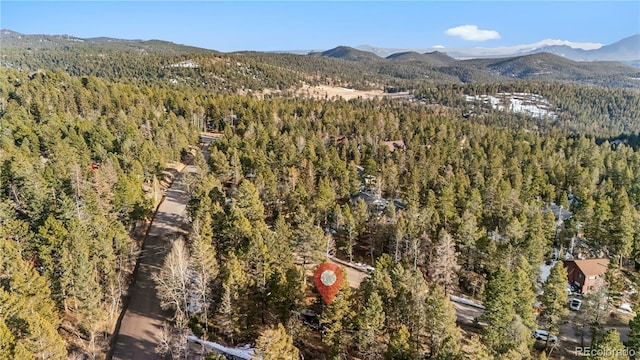 aerial view with a mountain view and a forest view