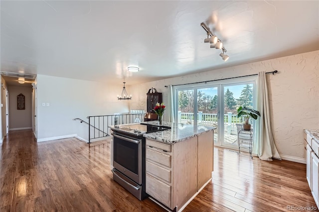 4090 S Tamarac Dr, Denver, CO 80237 - kitchen with stainless steel electric range oven, wood finished floors, light brown cabinets, rail lighting, and light stone counters