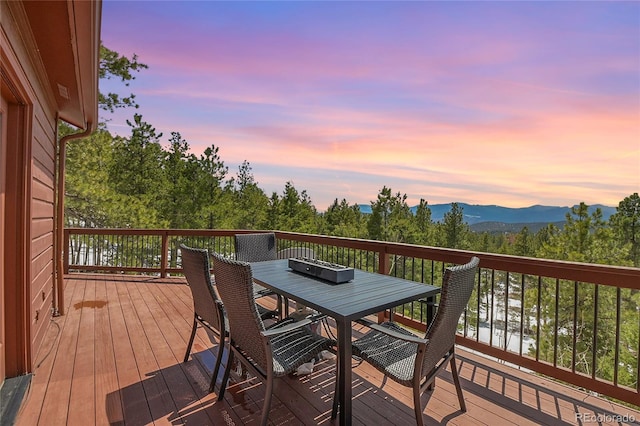 27100 Molly Dr, Conifer, CO 80433 - deck at dusk featuring outdoor dining area and a mountain view