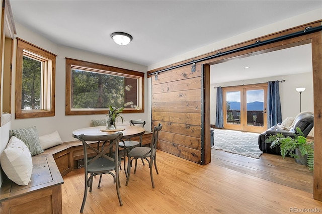 27100 Molly Dr, Conifer, CO 80433 - dining room featuring light wood finished floors and a barn door