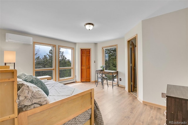 27100 Molly Dr, Conifer, CO 80433 - bedroom with an AC wall unit, a baseboard heating unit, light wood finished floors, and baseboards