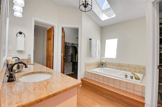 27100 Molly Dr, Conifer, CO 80433 - full bath with a skylight, a walk in closet, a bath, vanity, and lofted ceiling