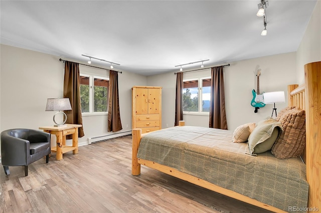 27100 Molly Dr, Conifer, CO 80433 - bedroom with track lighting, baseboard heating, and multiple windows