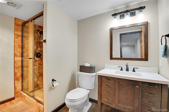 27100 Molly Dr, Conifer, CO 80433 - bathroom with wood finished floors, a stall shower, toilet, and vanity