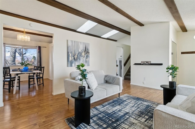6750 Lange, Colorado Springs, CO 80918 - living room featuring an inviting chandelier, vaulted ceiling with beams, hardwood / wood-style floors, and a textured ceiling