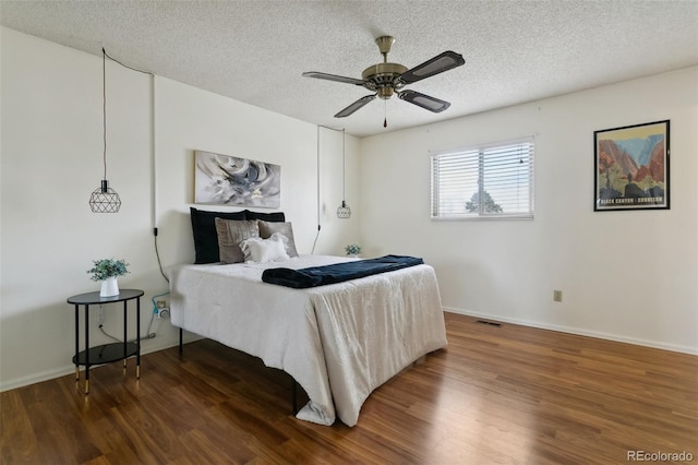 6750 Lange, Colorado Springs, CO 80918 - bedroom with ceiling fan, dark hardwood / wood-style floors, and a textured ceiling