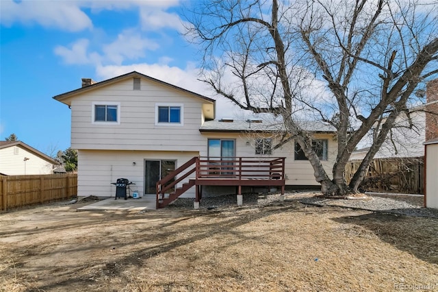 6750 Lange, Colorado Springs, CO 80918 - back of house with a wooden deck and a patio