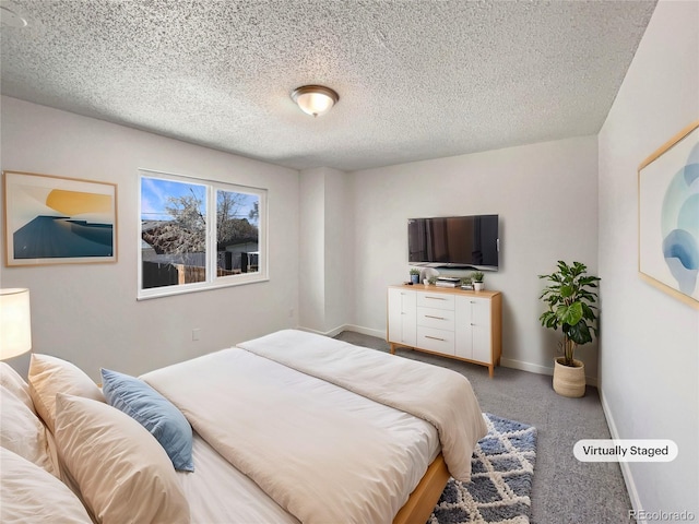 bedroom with carpet flooring, a textured ceiling, and baseboards