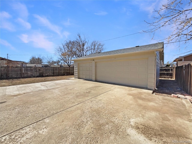 detached garage featuring fence