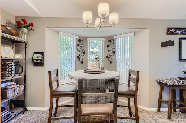 carpeted dining space featuring a chandelier