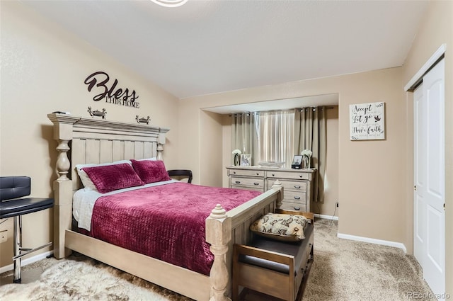 bedroom with lofted ceiling, carpet, and a closet