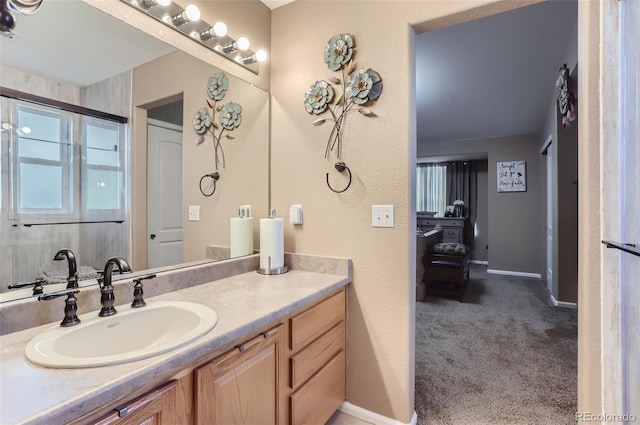 bathroom with a shower with door and vanity