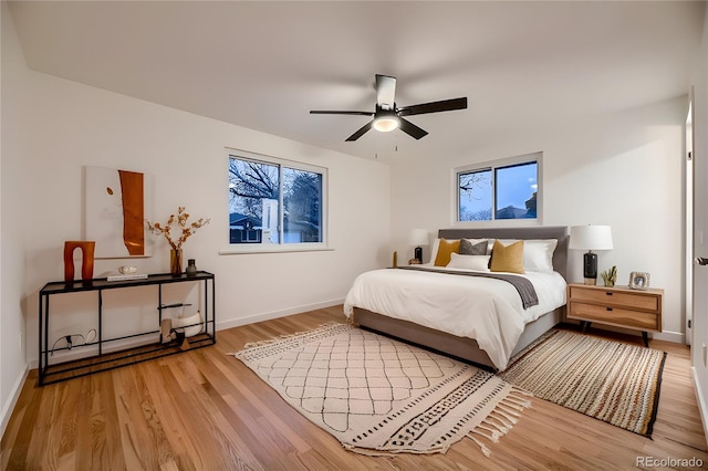 bedroom with ceiling fan and light hardwood / wood-style flooring