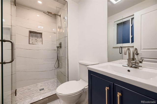 bathroom with walk in shower, vanity, and toilet