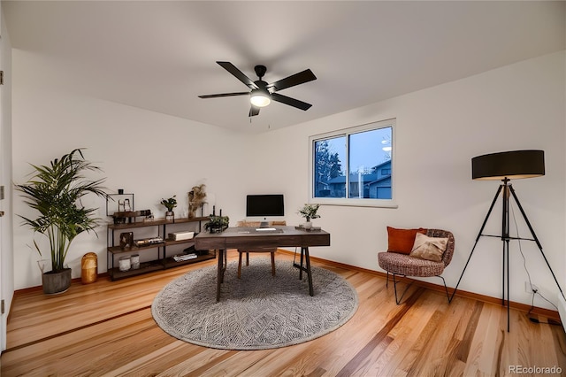 home office featuring wood-type flooring and ceiling fan