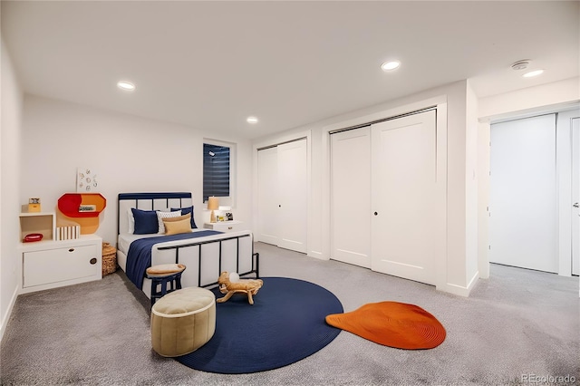 bedroom with carpet and two closets