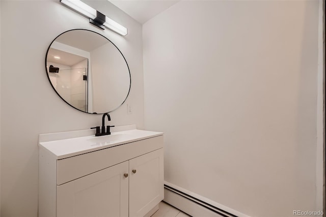 bathroom featuring tile patterned flooring, vanity, and a baseboard radiator