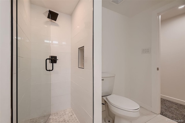 bathroom featuring walk in shower, tile patterned floors, and toilet