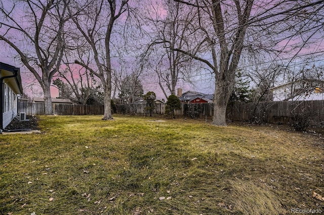 view of yard at dusk