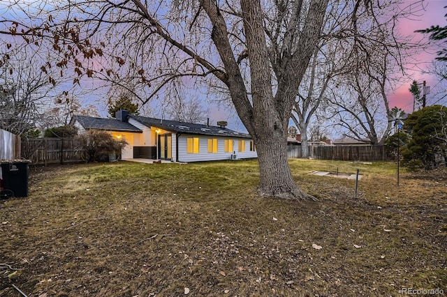 view of yard at dusk