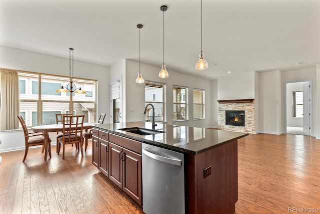 kitchen featuring plenty of natural light, sink, stainless steel dishwasher, and a kitchen island with sink