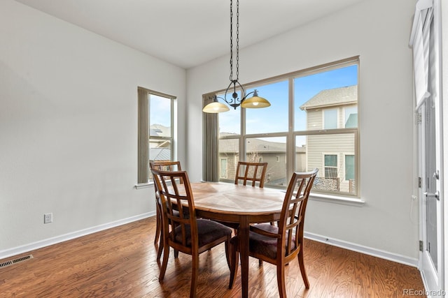 dining area with dark hardwood / wood-style floors