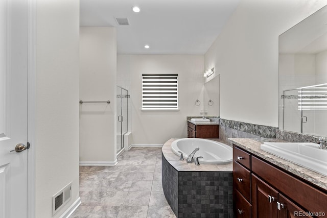 bathroom featuring vanity and shower with separate bathtub