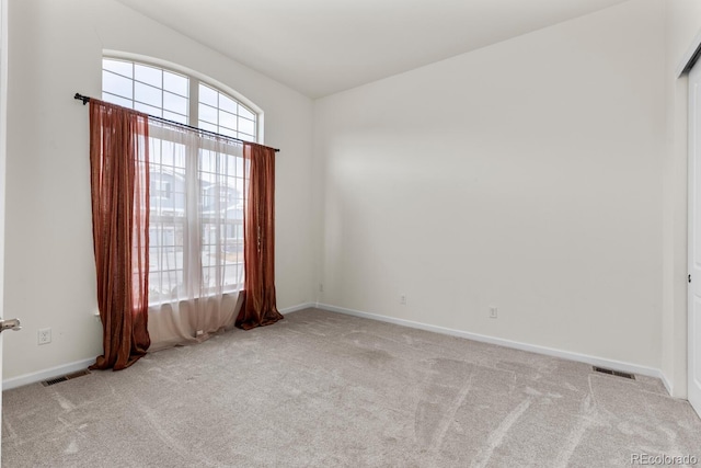 empty room featuring light colored carpet