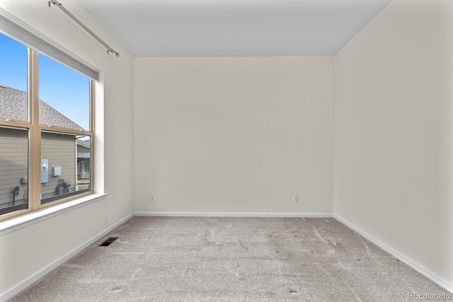 spare room with light colored carpet