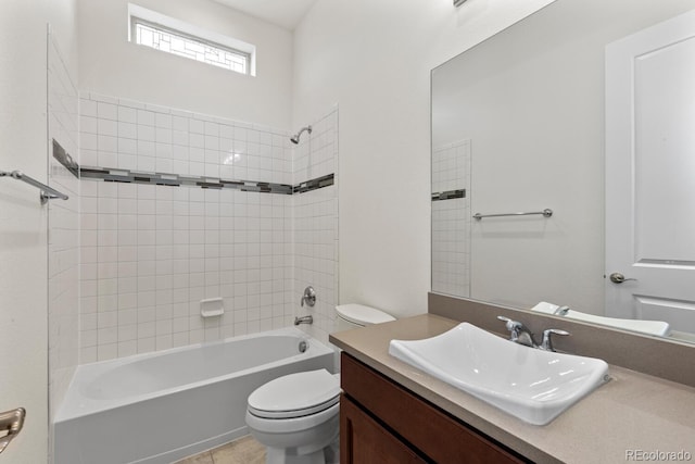 full bathroom with vanity, tiled shower / bath combo, and toilet