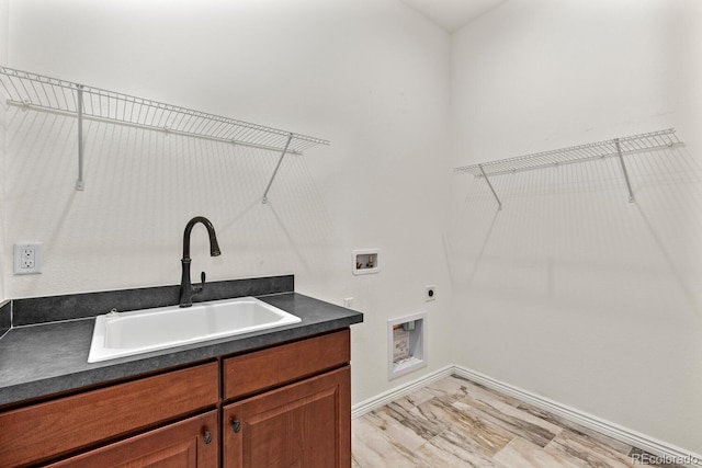 clothes washing area with hookup for a washing machine, electric dryer hookup, sink, and cabinets