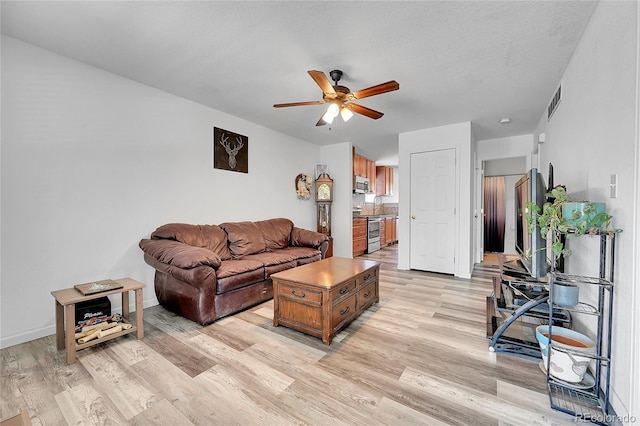 2791 Quarterland St, Strasburg, CO 80136 - living area featuring a ceiling fan, light wood finished floors, and baseboards