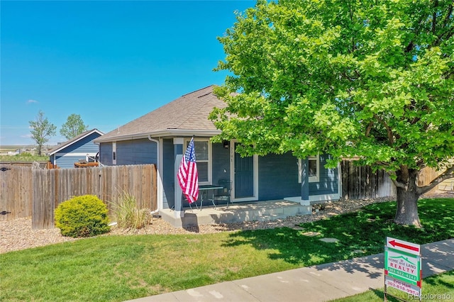 2791 Quarterland St, Strasburg, CO 80136 - obstructed view of property featuring a porch and roof with shingles