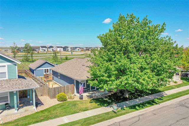 2791 Quarterland St, Strasburg, CO 80136 - view of front of property with a shingled roof, a residential view, and a patio area