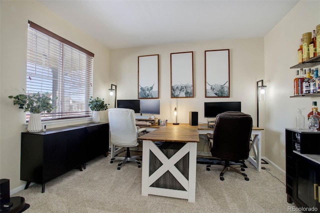 carpeted office space with plenty of natural light