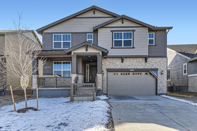 craftsman inspired home with stone siding, concrete driveway, and a garage