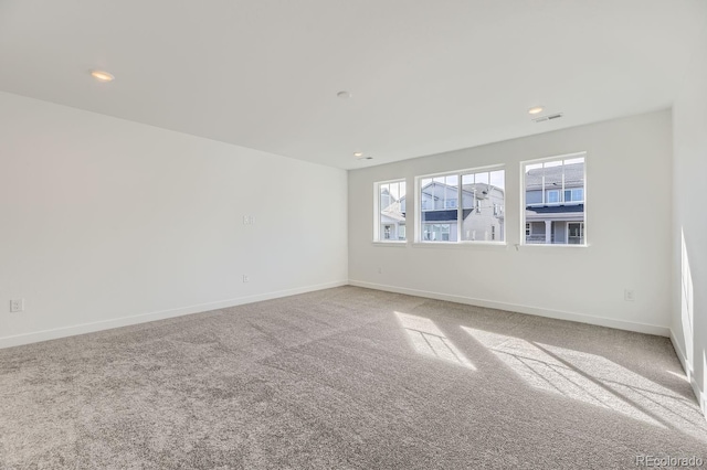 spare room featuring carpet, baseboards, visible vents, and recessed lighting