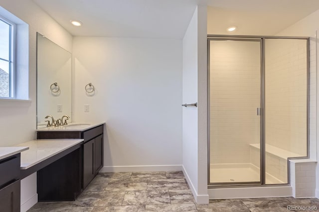 bathroom with recessed lighting, a shower stall, baseboards, and vanity