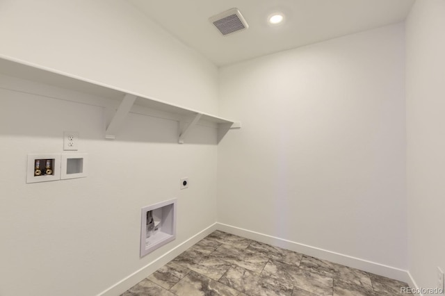 clothes washing area with hookup for a washing machine, visible vents, electric dryer hookup, laundry area, and baseboards