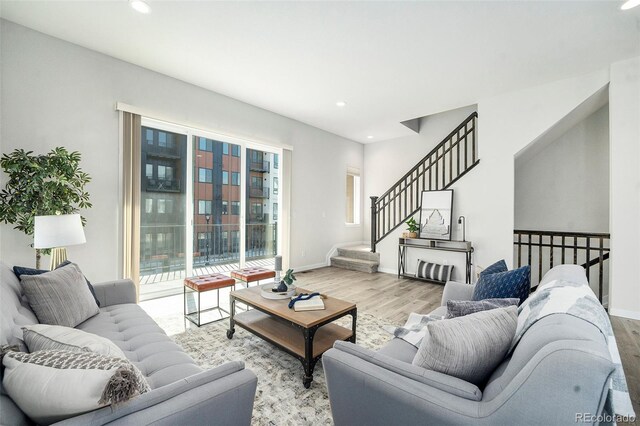 living area featuring recessed lighting, wood finished floors, and baseboards