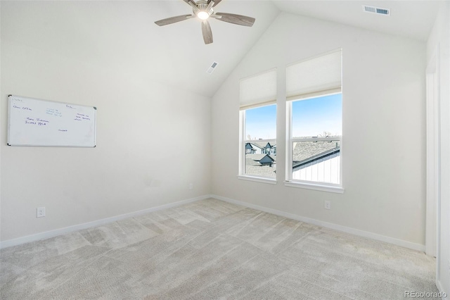 spare room with visible vents, light carpet, high vaulted ceiling, and baseboards