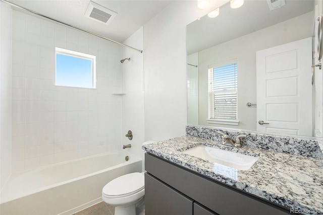 bathroom featuring a wealth of natural light, visible vents, and toilet