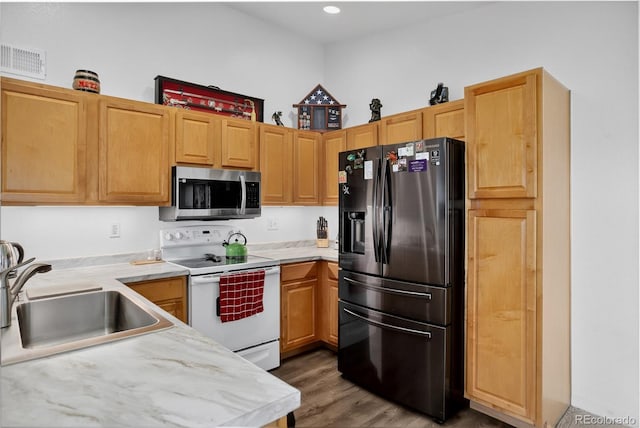 4875 S Balsam Way Unit 8-203, Littleton, CO 80123 - kitchen featuring stainless steel appliances, light countertops, wood finished floors, and recessed lighting