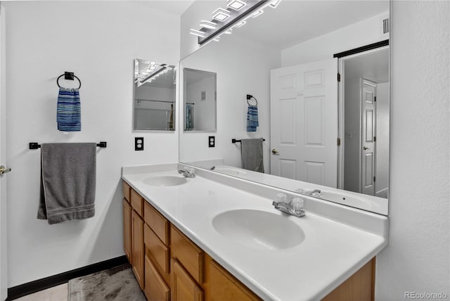 4875 S Balsam Way Unit 8-203, Littleton, CO 80123 - full bathroom featuring double vanity and baseboards