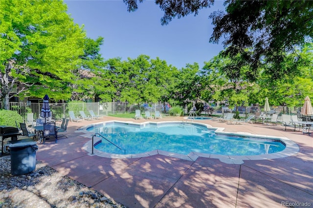 4875 S Balsam Way Unit 8-203, Littleton, CO 80123 - community pool featuring a patio and view of wooded area