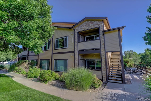 4875 S Balsam Way Unit 8-203, Littleton, CO 80123 - back of property with stairs and a patio