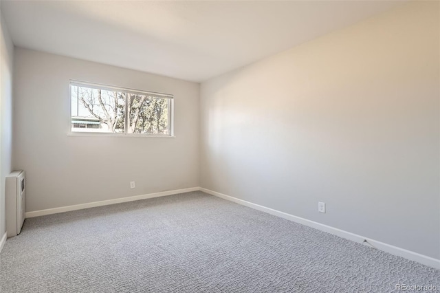 2201 S Holly St Unit 1, Denver, CO 80222 - empty room with radiator and carpet floors
