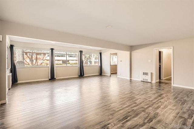 2201 S Holly St Unit 1, Denver, CO 80222 - empty room featuring dark wood-style flooring and heating unit