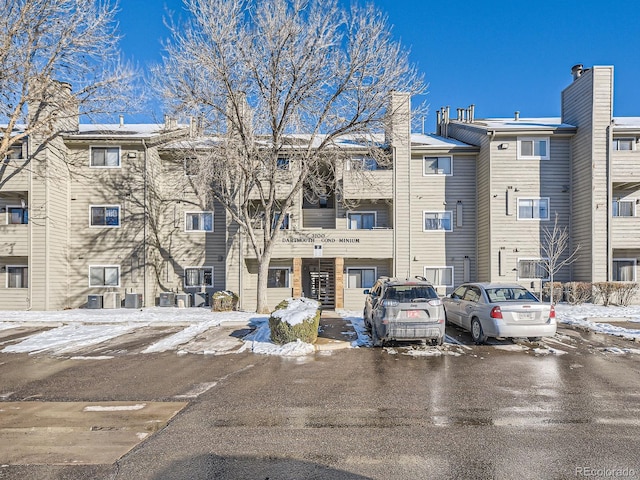 snow covered property featuring central air condition unit