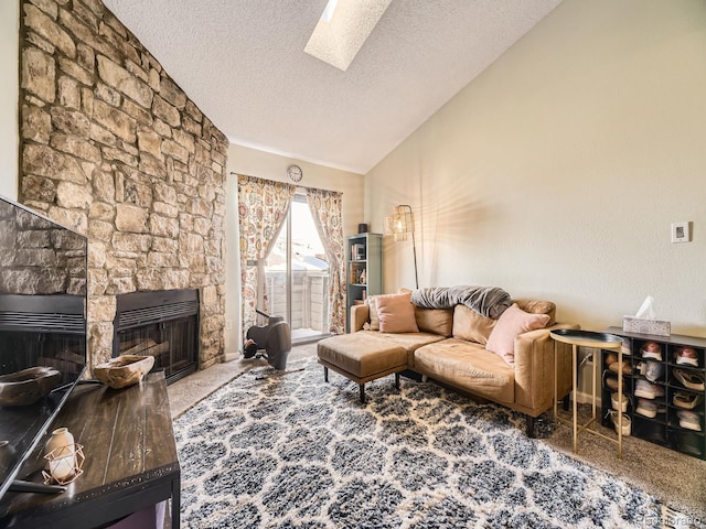 carpeted living room with lofted ceiling with skylight, a textured ceiling, and a fireplace